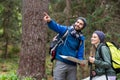 Hiker couple looking at map and pointing away Royalty Free Stock Photo