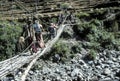 Hiker crossing suspension bridge Royalty Free Stock Photo