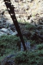 Hiker crossing suspension bridge Royalty Free Stock Photo