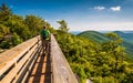 Hiker crossing a walking bridge on Big Schloss, in George Washington National Forest, VA.