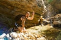 Hiker drinking water from the river. Man enjoys clean fresh unpolluted water in the mountain creek