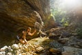 Hiker drinking water from the river. Man enjoys clean fresh unpolluted water in the mountain creek