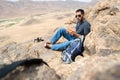 Hiker eating a snack on the edge of a mountain in the desert Royalty Free Stock Photo