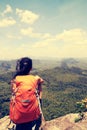 Hiker enjoy the view at mountain peak cliff Royalty Free Stock Photo