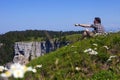 Hiker enjoying breathtaking landscape from top of cliff in Switzerland