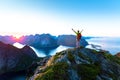 Hiker enjoying midnight sun during arctic summer, Reine, Lofoten, Norway Royalty Free Stock Photo