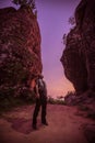 Solo Travellers. Hiker enjoying the view, against silhouette of rock mountains at sunset, Three whale rock mountain