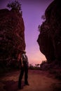 Hiker enjoying the view, against silhouette of rock mountains at sunset, Three whale rock mountain