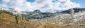 Hiker enjoying view on beautiful alpine valley with fresh snow, panorama, Mt Assiniboine PP, Canada Royalty Free Stock Photo