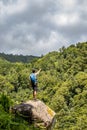 Hiker enjoying view, landscape at Azores islands, green vegetation, hills.