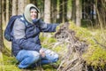 Hiker at the fallen tree roots in forest Royalty Free Stock Photo