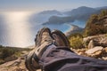 Hiker feet in trekking boots on the Lycian Way .over Oludeniz Blue Lagoon in Mugla province, fethiye