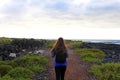 Hiker female walking in Lanzarote. Back view of young woman hiki