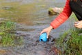 Hiker filling canteen with river raw water