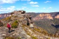 Hiker final destination of a mountain trek, reaching summit Royalty Free Stock Photo