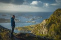 Hiker in front Fishing village HenningsvÃÂ¦r at Lofoten Islands