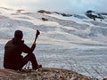 Hiker in front of a great alpine glacier. Back view. Italian Alp