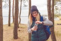 Hiker girl enjoying water. Happy woman tourist with backpack drinking water from bottle in nature. Royalty Free Stock Photo