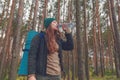 Hiker girl enjoying water. Happy woman tourist with backpack drinking water from bottle in nature. Royalty Free Stock Photo