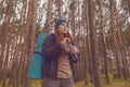 Hiker girl enjoying water. Happy woman tourist with backpack drinking water from bottle in nature. Royalty Free Stock Photo