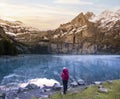 A hiker girl near mountain lake in Switzerland. Lake Oeschinensee in Swiss alps Royalty Free Stock Photo