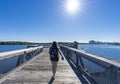 Woman hiking on the pathway over the lake. Royalty Free Stock Photo