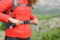 Hiker hands adjusting backpack straps in nature