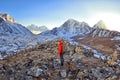 Hiker happy woman trekking on the snow in a snowy mountain Royalty Free Stock Photo