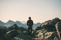 Hiker in high altitude rocky mountain landscape. Summer adventures on the Italian French Alps, toned image. Royalty Free Stock Photo