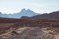 Hiker in high altitude rocky mountain landscape. Summer adventures on the Italian French Alps, toned image. Royalty Free Stock Photo