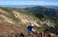 Hiker high on mountain ridge