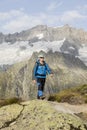 Hiker hikes through a breathtaking alpine landscape in the mountains Royalty Free Stock Photo