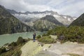 Hiker hikes through a wild high alpine landscape with a lake