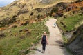 A hiker hiking on the beautiful track with a landscape of the mountains and Lake Wanaka. Roys Peak Track, South Island, New