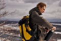 hiker hiking in forest going to drink tea from thermos wearing cold weather accessories Royalty Free Stock Photo