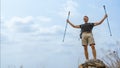 Hiker hiking success on rocky hill top