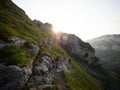 Hiker on hiking trail path along mountain cliffs in Alpstein swiss alps Appenzell Innerrhoden Switzerland Royalty Free Stock Photo