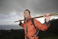 Hiker Holding Stick Across Shoulders On Hillside