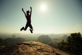 Hiker jumping on sunrise mountain top