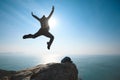 Hiker jumping on sunrise seaside cliff edge Royalty Free Stock Photo