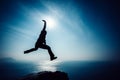 Hiker jumping on sunrise seaside Royalty Free Stock Photo