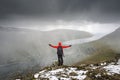 Hiker on the Klakkur mountain above the city of Klaksvik on Faroe Islands