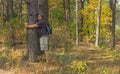 Hiker leans to a tree beeing charging by positive nergy