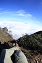 hiker legs sit on beautiful mountain peak enjoy the view Royalty Free Stock Photo