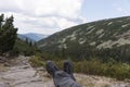 Hiker lies on the stones, with a view into the valley Royalty Free Stock Photo