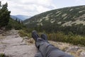 Hiker lies on the stones, with a view into the valley Royalty Free Stock Photo