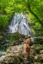 Hiker looking at beautiful waterfall in North Carolina forest Royalty Free Stock Photo