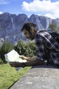 A hiker looking at a map in a sunny day Royalty Free Stock Photo