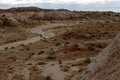 Hiker looks across desert landscape at the Bisti Badlands in New Mexico Royalty Free Stock Photo