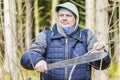 Hiker with machete in forest